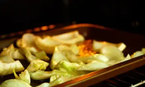 Roasted fennel wedges seasoned with herbs and spices, ready for delicious fennel recipes.