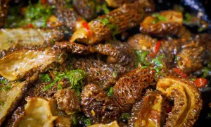 Sautéed morel mushrooms with herbs and chili, showcasing the best way to cook morel mushrooms for a delicious meal.