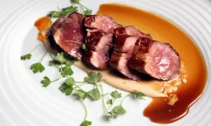Perfectly seared Iberico pork slices, glistening with sauce and garnished with fresh parsley. This dish showcases how to cook Iberico pork to tender perfection.