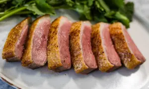 Perfectly seared duck breast, sliced and ready to serve. This duck breast recipe yields tender, juicy meat with a crispy skin.