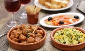 A delicious spread of albondigas españolas, tapas, and wine, perfect for a Spanish feast.