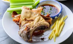 Crispy fried fish collar served with celery sticks, ginger matchsticks, and a dipping sauce. A delicious fish collar recipe.