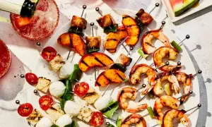 Grilled shrimp, peaches, and caprese skewers are a delicious tapas recept.