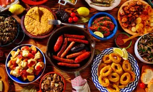A vibrant spread of Spanish tapas: fried calamari, grilled sardines, chorizo, patatas bravas, and more. These small plates are perfect for sharing!