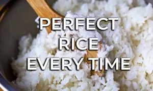 Fluffy white rice being stirred with a wooden spoon. Learn how to cook rice perfectly every time for delicious meals.