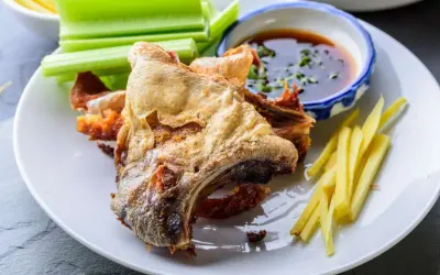 Crispy fried fish collar served with celery sticks, ginger matchsticks, and a dipping sauce. A delicious fish collar recipe.