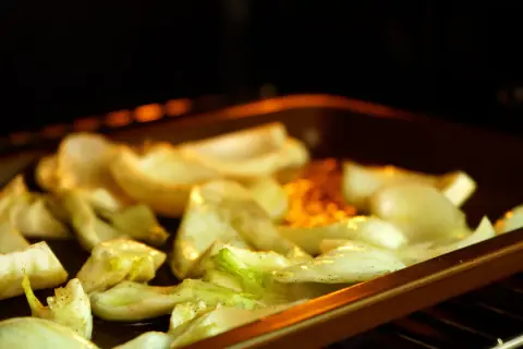 Roasted fennel wedges seasoned with herbs and spices, ready for delicious fennel recipes.