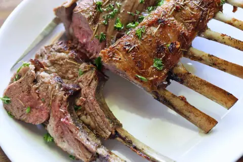A perfectly cooked rack of lamb, seasoned and roasted to perfection. This delicious roast lamb recipe is a showstopper!