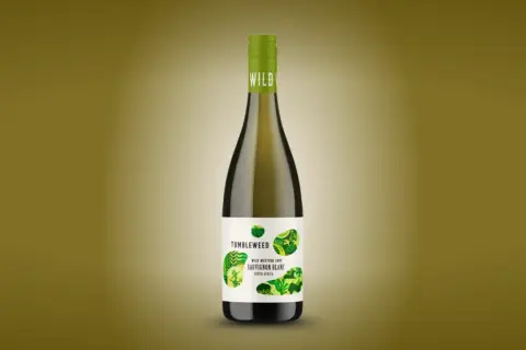 A bottle of Tumbleweed Sauvignon Blanc, a dry white wine from South Africa, with a green cap and a label featuring abstract green leaf patterns.
