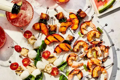 Grilled shrimp, peaches, and caprese skewers are a delicious tapas recept.