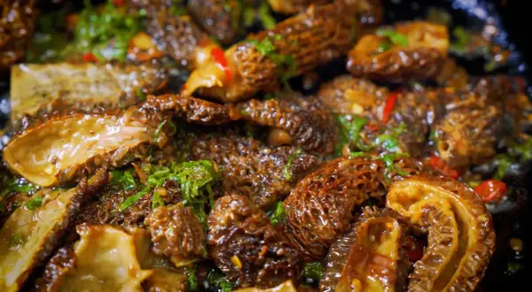 Sautéed morel mushrooms with herbs and chili, showcasing the best way to cook morel mushrooms for a delicious meal.