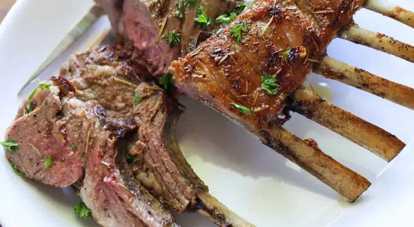 A perfectly cooked rack of lamb, seasoned and roasted to perfection. This delicious roast lamb recipe is a showstopper!