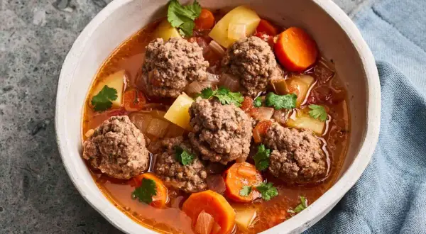 Hearty albondigas soup from Spain, with tender meatballs, potatoes, carrots, and cilantro in a rich broth.