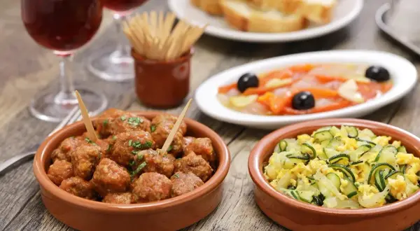 A delicious spread of albondigas españolas, tapas, and wine, perfect for a Spanish feast.
