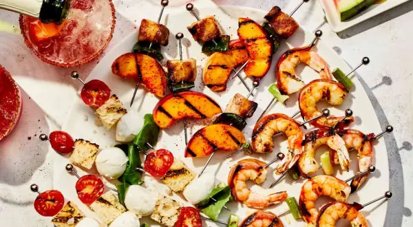 Grilled shrimp, peaches, and caprese skewers are a delicious tapas recept.