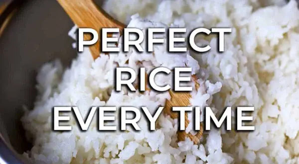 Fluffy white rice being stirred with a wooden spoon. Learn how to cook rice perfectly every time for delicious meals.