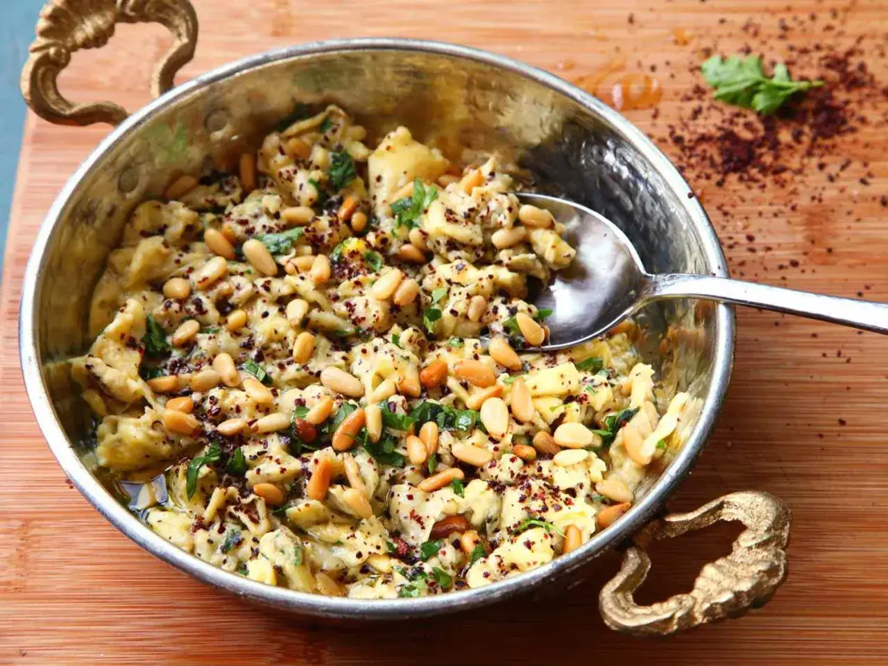 A delicious dish featuring scrambled eggs with pine nuts, herbs, and spices, perfect for exploring pine nut recipes.