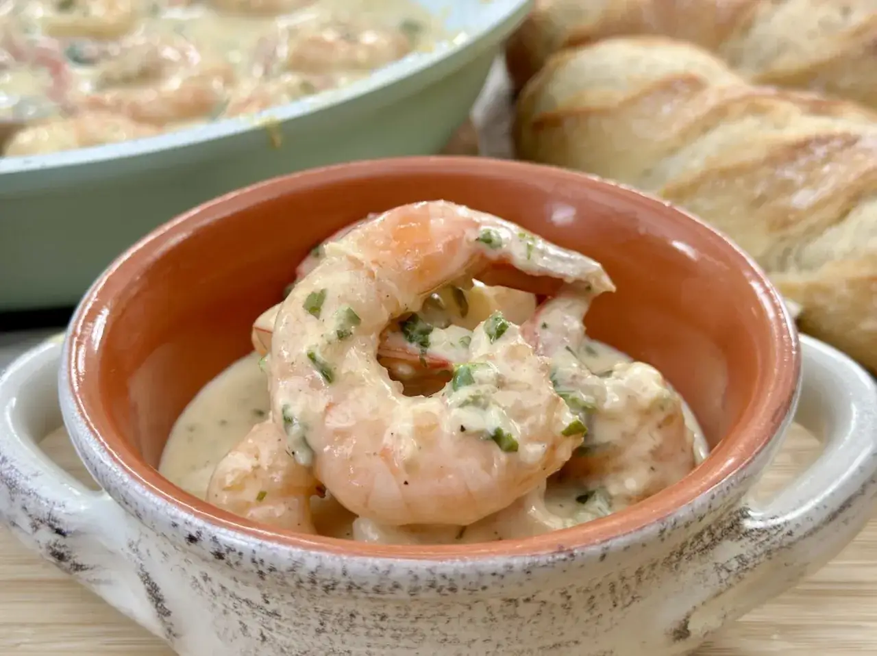 Creamy garlic shrimp in a rustic bowl, part of delicious shrimp recipes, served with crusty bread.