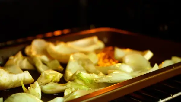 Roasted fennel wedges seasoned with herbs and spices, ready for delicious fennel recipes.