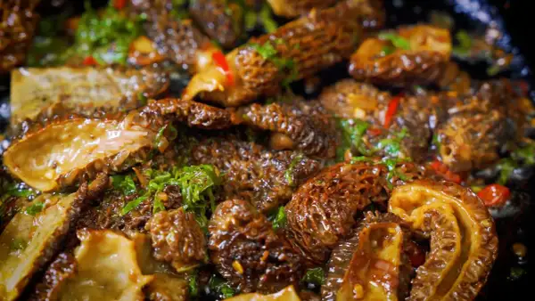 Sautéed morel mushrooms with herbs and chili, showcasing the best way to cook morel mushrooms for a delicious meal.