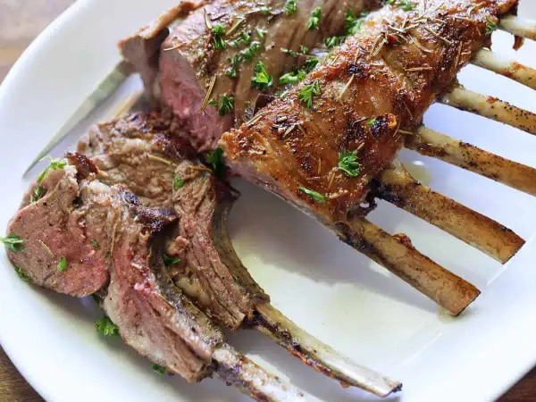 A perfectly cooked rack of lamb, seasoned and roasted to perfection. This delicious roast lamb recipe is a showstopper!